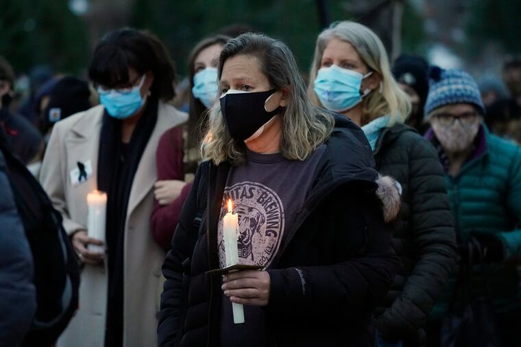 Mourners listened to speakers at a vigil for the 10 victims of the Monday massacre at a King Soopers grocery store late Thursday at Fairview High School in Boulder, Colo.