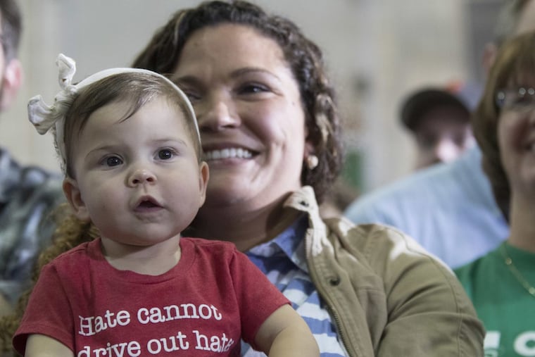 Aryanna Berringer, former candidate for Pennsylvania lieutenant governor, holds her daughter Atlee as she listens to Democratic presidential candidate Hillary Clinton in Pittsburgh in 2016.
