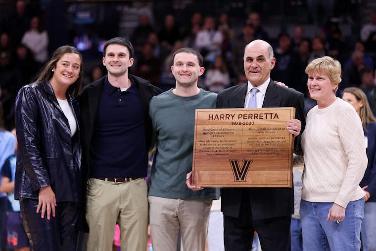 Former Villanova women's head coach Harry Perretta (fourth from left) holds a plaque commemorating his time at the school during halftime of the Wildcats game against Georgetown on Saturday.