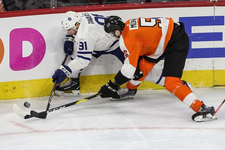 The Flyers' Samuel Morin and Maple Leafs' John Tavares (91) battle for the puck during the first period.