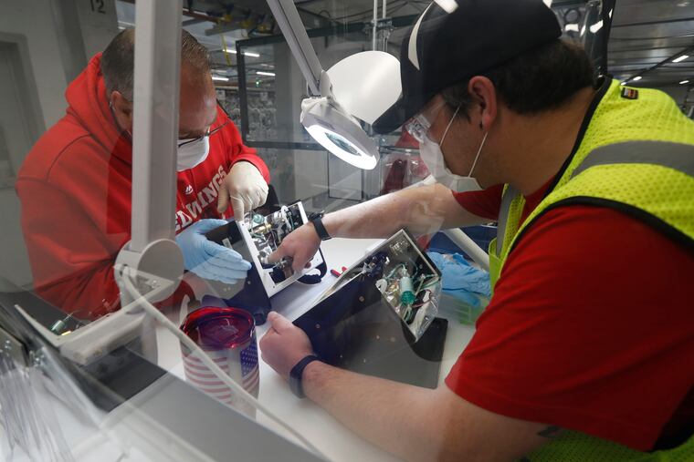 Ford Motor Co. employees work a ventilator at the Rawsonville plant in Ypsilanti Township, Mich. The plant was converted into a ventilator factory, as hospitals battling the coronavirus report shortages of the life-saving devices. According to the Institute for Supply Management, U.S. manufacturing rebounded in June 2020 as major parts of the country opened back up.