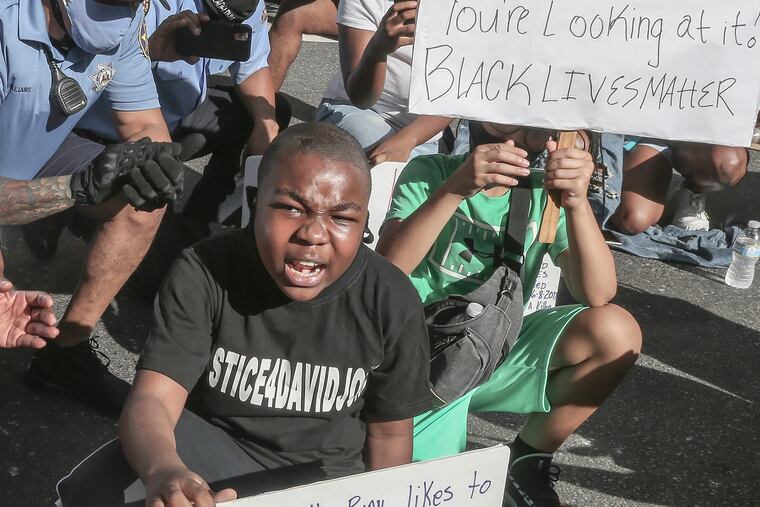 11-year-old Isaac Gardner Jr. speaks about injustice near the criminal Justice Center during the Defenders March, Monday, June 8, 2020