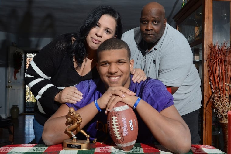 Ojay Harris (center) with his mother Dawn Harris and father Shannon Harris.