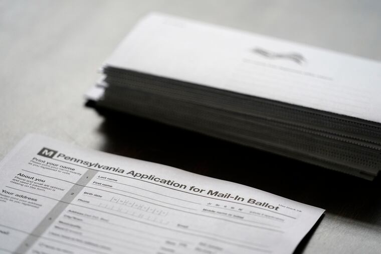 Applications for mail ballots are seen at a satellite election office at Temple University’s Liacouras Center Sept. 29 in Philadelphia.