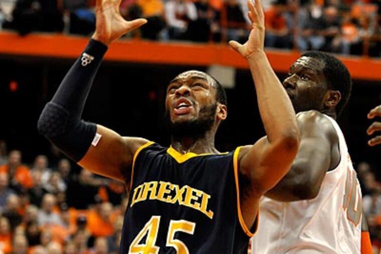 Drexel's Samme Givens tries to control the ball against Syracuse's Rick Jackson during the first half. (AP Photo/Kevin Rivoli)