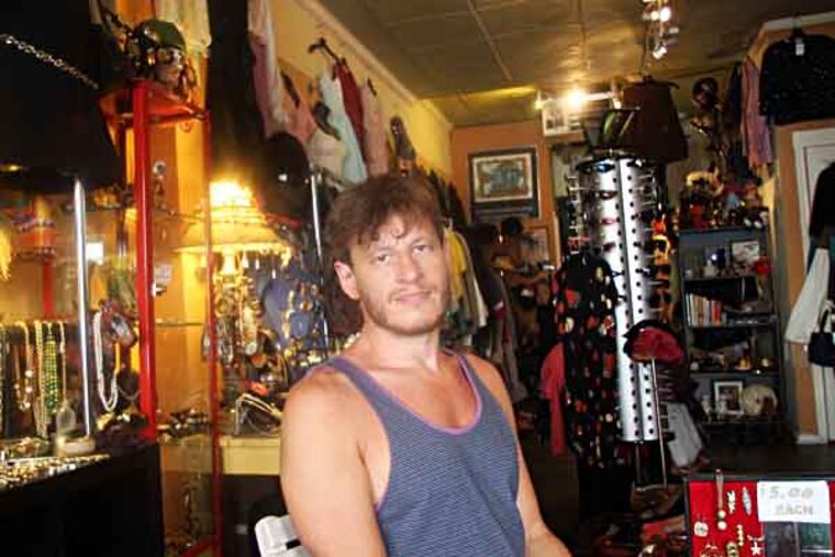 Dan Wilbur, owner of Wilbur Vintage Designer Clothes & Accessories in Queen Village, sits in his store on Monday, July 15, 2013. ( Yong Kim / Staff Photographer )