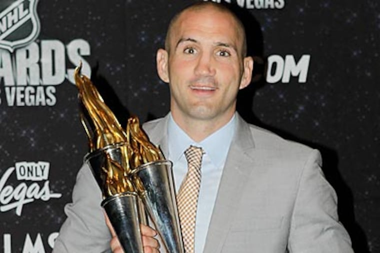 Ian Laperriere poses with the Bill Masterton Memorial Trophy, which he won at last night's NHL Awards. (Julie Jacobson/AP)