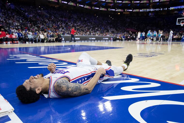 Danny Green of the Sixers lies on the court after injuring his right hip against the Charlotte Hornets during on Jan. 12 at the Wells Fargo Center.
