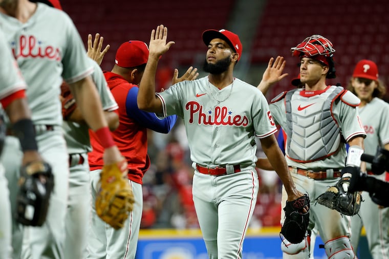 Phillies reliever Seranthony Dominguez (58) is congratulated by teammates after completing the save against the Cincinnati Reds at Great American Ball Park on Monday, Aug. 15, 2022, in Cincinnati.