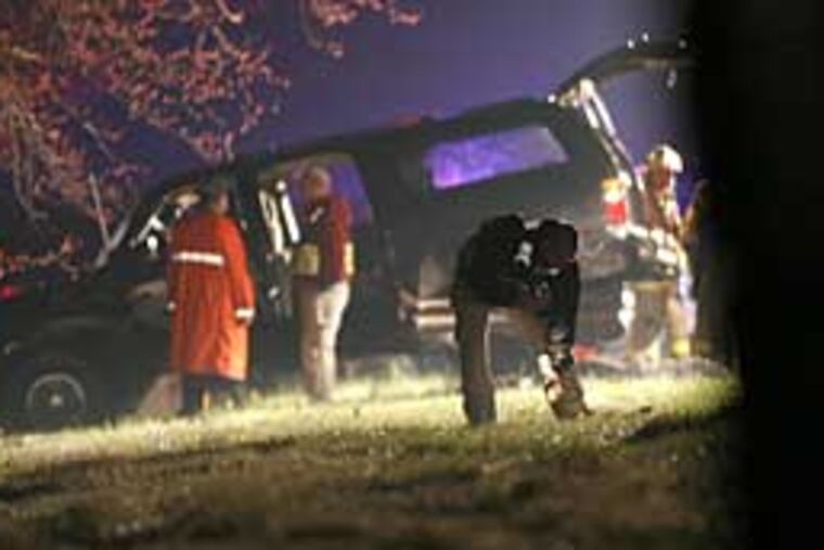 The SUV that carried N.J. Gov. Jon S. Corzine sits over the guardrail on the Garden State Parkway after yesterday's crash in Galloway Township. Cooper University officials said he was stable, with fractured ribs, a broken left leg and chest injuries.