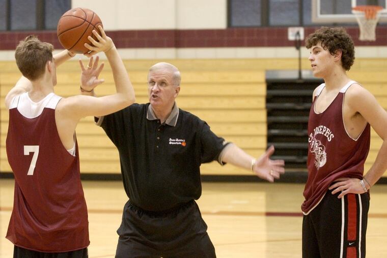St. Joseph’s Prep basketball coach Speedy Morris (center) can win his 1,000th game on Friday. Here he works with two players at a 2002 practice.