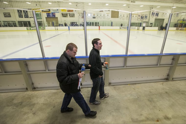 Matt Wallace (left) is color commentator to his play-by-play broadcast partner Sam Fryman during University of Pennsylvania women’s ice hockey games. Matt has been blind since birth. The Temple grads walk by the rink before a recent game between Penn and Villanova.