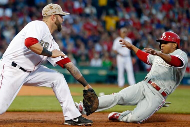 Boston's Mike Napoli puts the tag on Ben Revere as he is doubled off first base in the third inning. (Michael Dwyer/AP)