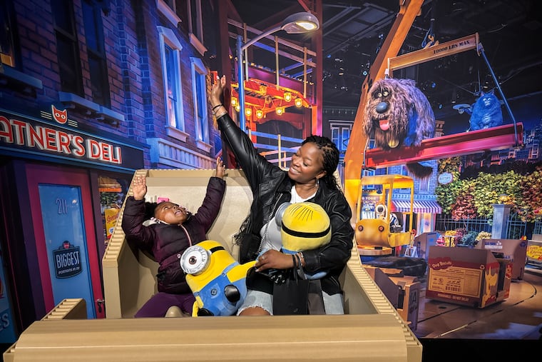 Kame Paige, left, and her aunt Brittiny Stewart, right, have fun at the new exhibit at The Franklin Institute that pays homage to Universal's theme parks, in Philadelphia, Wednesday, Feb. 12, 2026, in Philadelphia
