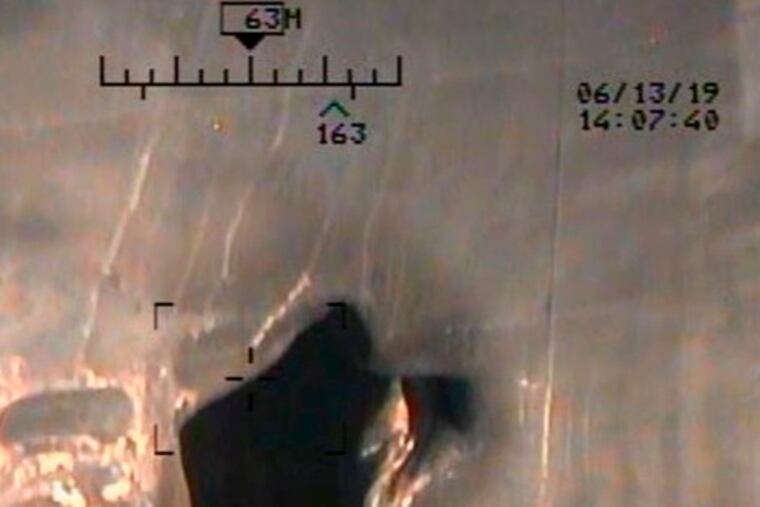 This image released by the U.S. Department of Defense on Monday, June 17, 2019, and taken from a U.S. Navy helicopter, shows what the Navy says is blast damage to the motor vessel M/T Kokuka Courageous, consistent with a limpet mine attack. (U.S. Department of Defense via AP)