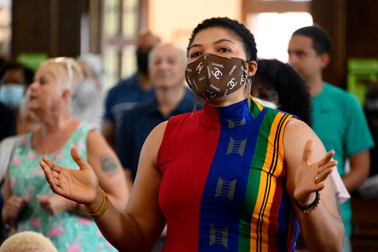 Princess Koroma, of Philadelphia, attends Sunday mass at St. Raymond of Penafort in Mount Airy. Sunday marked a return of the Archdiocese of Philadelphia's in-person Mass obligation.