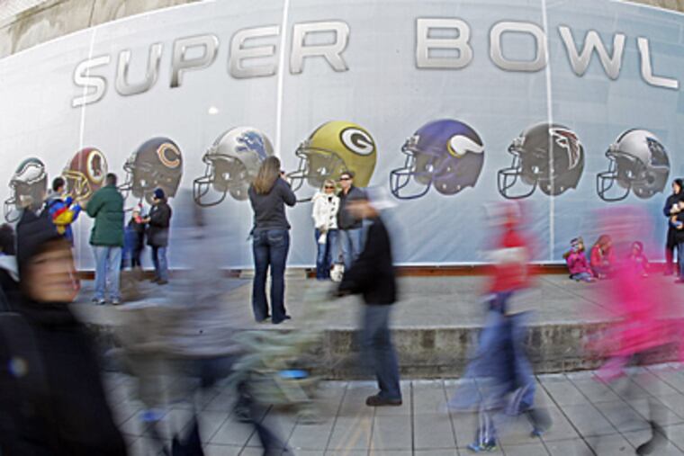 Super Bowl Village, with plenty of attractions, is drawing fans in Indianapolis. (Mark Humphrey / Associated Press)