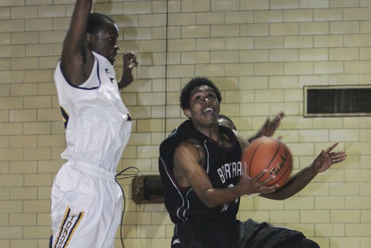Malik Smith’s drive is contested by Esperanza’s Mohamed Sherif.