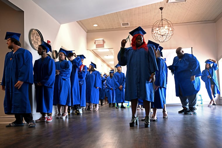 Helms Academy students line up at the Camden County Boathouse on Thursday for the procession to their graduation ceremony.