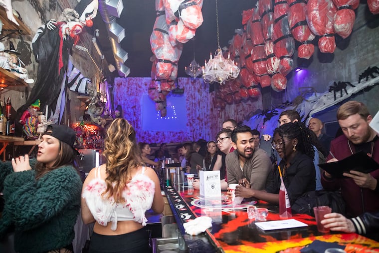 The Halloween-themed "The Nightmare Before Tinsel" pop-up bar in Center City draws a rowdy crowd on a mid-October evening.