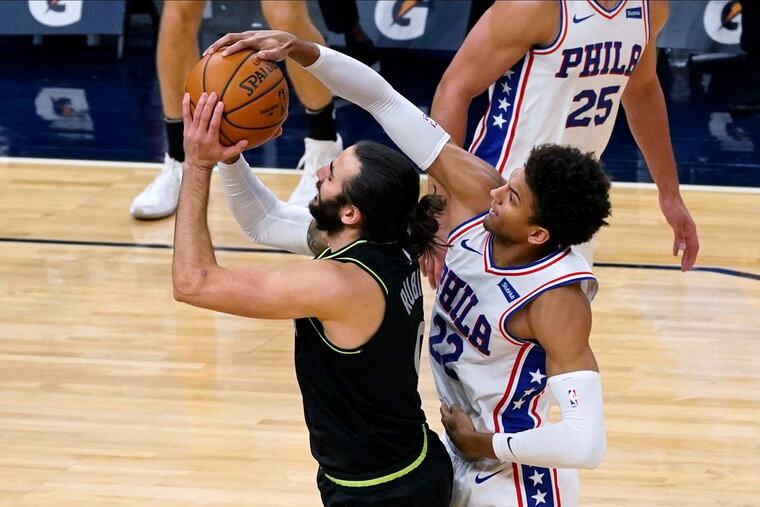 Matisse Thybulle (22) blocks Minnesota's Ricky Rubio (9) from shooting during the second half.