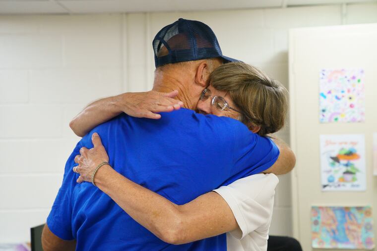 A Living Room regular gets a hug from Sister Eileen Sizer,