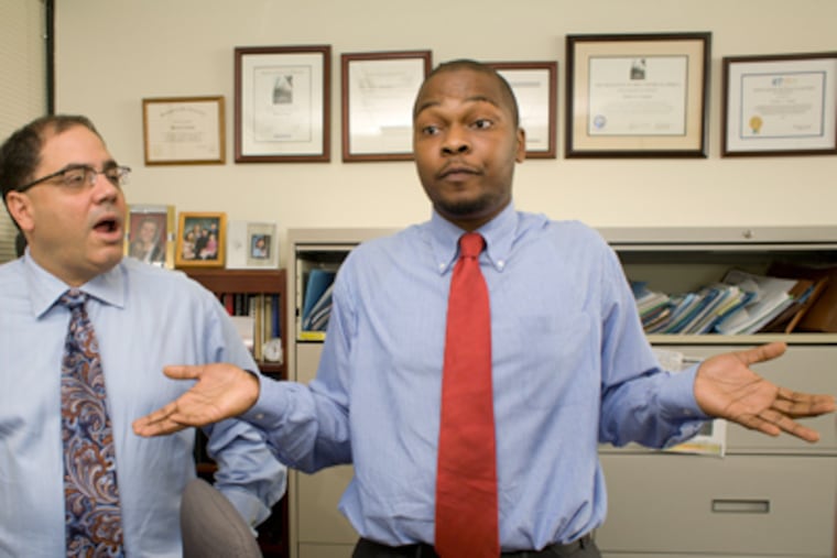 Emil Van Otoo, right, and his attorney James Famiglio, left, talk about Otoo's 2009 arrest. (Ed Hille / Staff Photographer)