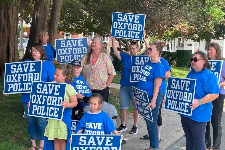 Residents protest against the disbanding of Oxford borough's police department. Council is expected to vote later this month to dissolve their own department and instead join the Southern Chester County Regional Police Department, with three other municipalities.