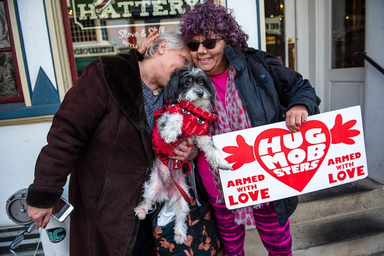 Edie Weinstein, founder of the Hug Mobsters, gives a hug to Barbara Reich, 78, in Doylestown.