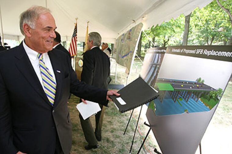 Pennsylvania Gov. Edward Rendell looks over a schematic of the proposed changes to the Scudder falls Bridge on I-95.(Charles Fox / Staff Photographer)