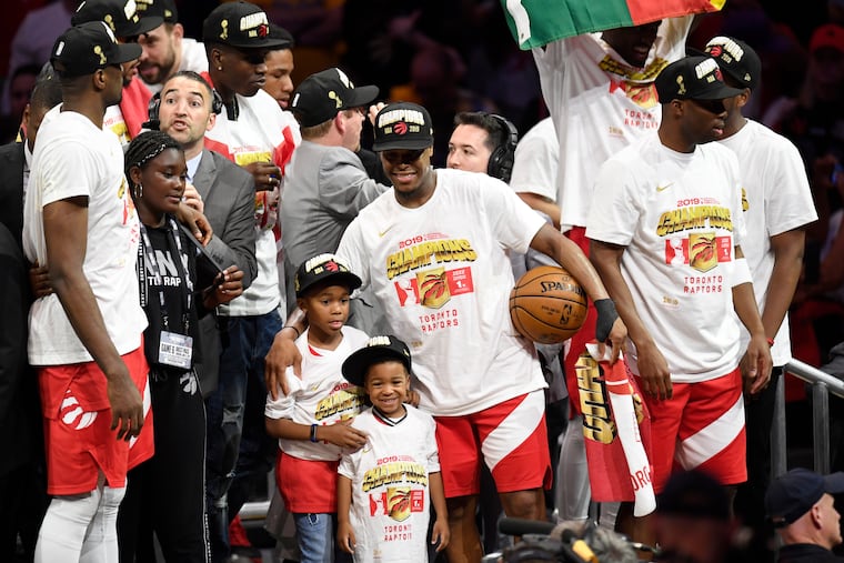 Kyle Lowry (center) celebrates with his sons on the stage after the Toronto Raptors beat the Golden State Warriors in Game 6 of the NBA Finals and won the championship/