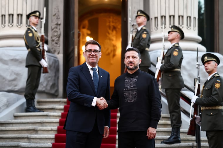 Ukrainian President Volodymyr Zelensky welcomes and shakes hands with British Prime Minister Andy Burnham upon his arrival at Horodetskyi House ahead of their bilateral meeting in Kyiv, Ukraine, on Monday.