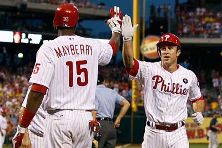Chase Utley is congratulated by John Mayberry Jr. after scoring in the first inning. (Yong Kim/Staff Photographer)