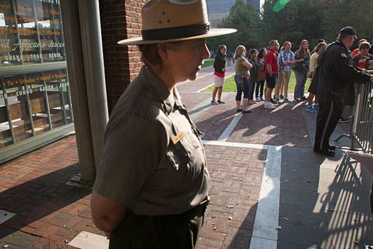 Jane Cowley, with the Independence National Park, stands outside the closed main entrance to Liberty Bell pavilion on Tuesday morning. (Alexander A. Alejandro/Staff)