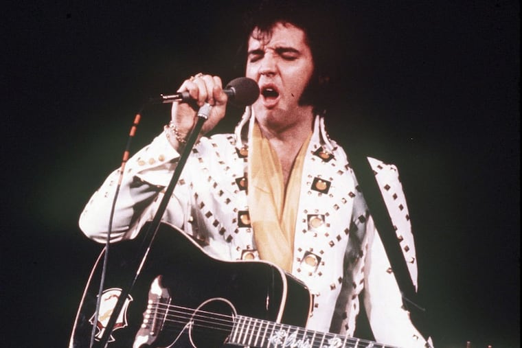 Elvis Presley, who died 40 years ago on Aug. 16, sings during a concert in 1973.
