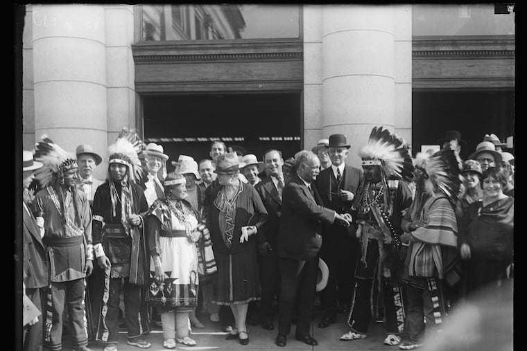 Vice President Charles Curtis, center, with arm extended, shakes hands with other Native Americans in an undated photograph from the National Archives.