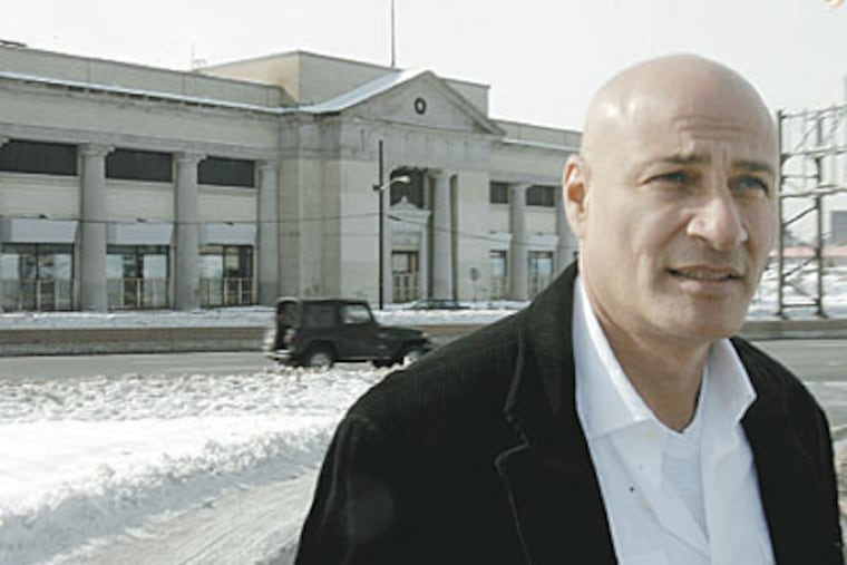 Clothing mogul Ilan Zaken at the landmark that Campbell wants to raze for expansion. (AKIRA SUWA / Staff Photographer)