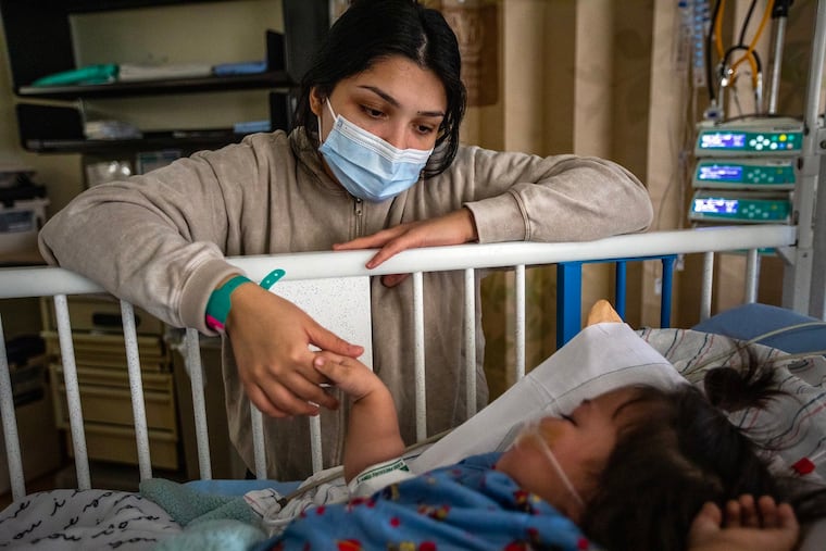 A mother watches an infant hospitalized with RSV at Loma Linda University Children's Hospital in California in 2022. The next year, a promising new drug that protects against RSV became available. New research from the Children’s Hospital of Philadelphia shows the challenges of getting families to accept it.