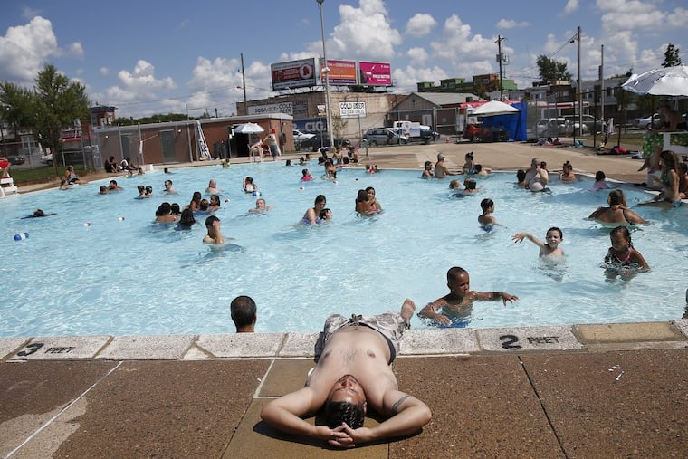 In a 2016 file photo, David Rodriguez, of North Philadelphia, relaxes on the edge of the Cione Pool as his children play in the water.