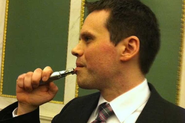 Gregory Conley of Medford, NJ, told a Philadelphia Council committee hearing testimony on bills to restrict e-cigarettes Thursday that a ban on their use in restaurants and other public places would be impossible to enforce. He used this e-cigarette 20 or 25 times while sitting in the back of the room during the hearing, he told them, and no one noticed. (Photo was taken after the hearing.) Photo: Don Sapatkin / staff