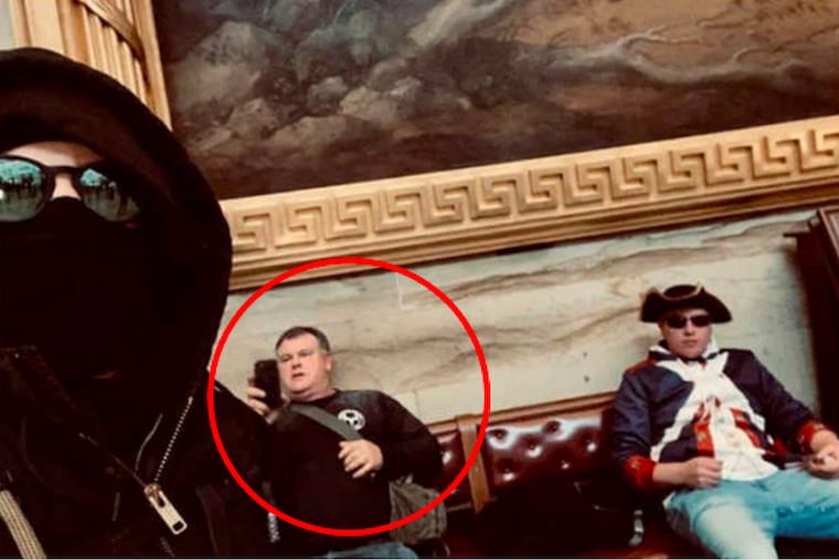 In this still image taken from a Justice Department court filing, a man FBI agents identified as Robert Lee Petrosh (red circle) looks at his cell phone inside the Capitol during the Jan. 6 riot.