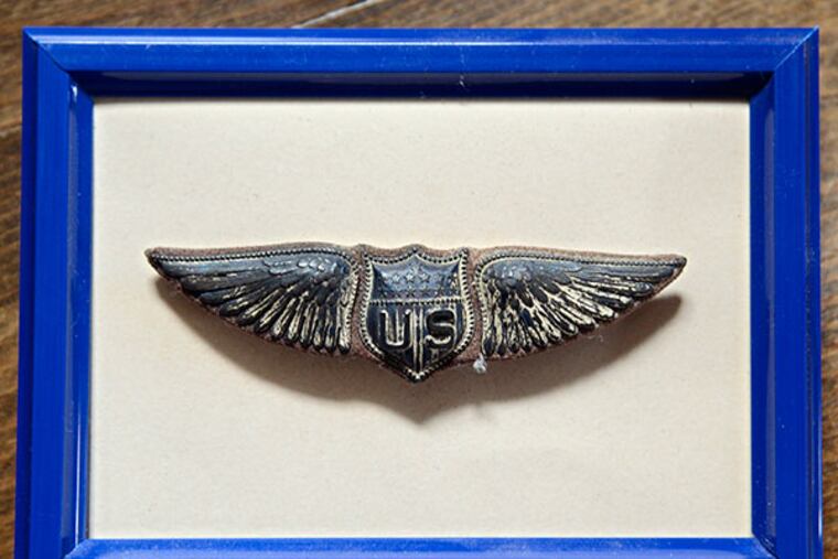 Dick Zahn displays his father's flight wings at his home April 18, 2014. ( TOM GRALISH / Staff Photographer )