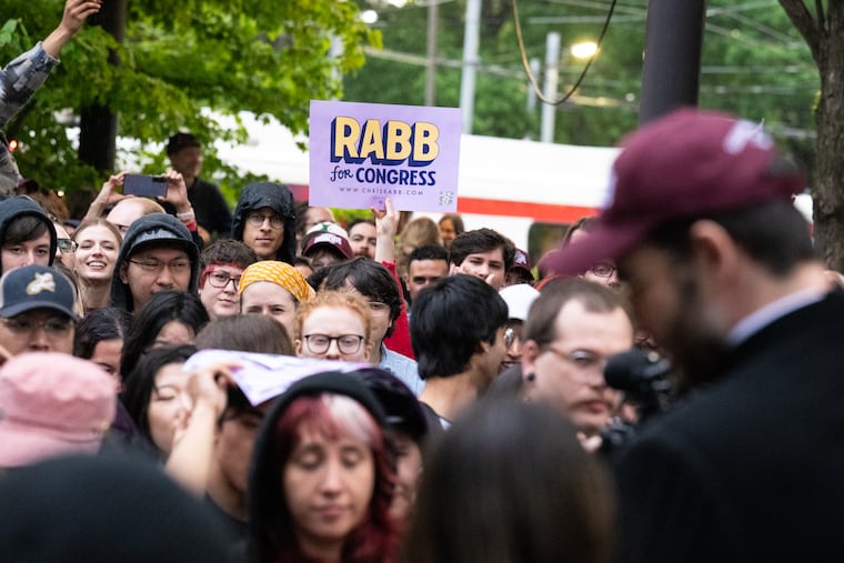 Leftist influencer Hasan Piker (right) speaks to attendees holding signs at a fundraiser for Pa. State Rep. Chris Rabb’s 2026 congressional campaign at Renata’s Kitchen in West Philadelphia on Thursday, April 30, 2026. 