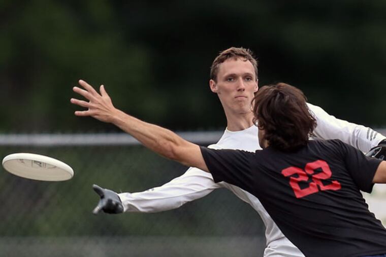Marshall Ward throws around Michael Panna during Spinners practice. (Steven M. Falk/Staff Photographer)