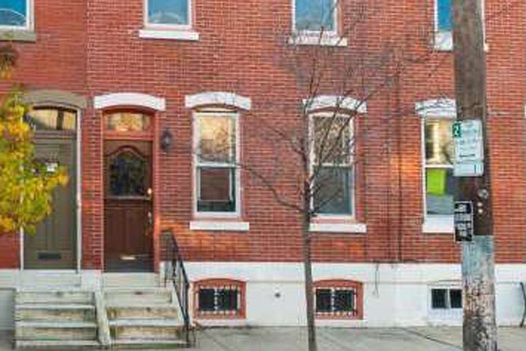 The Victorian home features period details like original woodwork and plaster moldings as well as a curved foyer entry hall. Those elements are juxtaposed with recent upgrades like the gourmet kitchen with granite counters and a large center island.