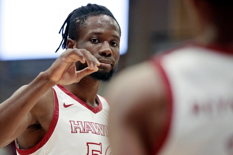 St. Joe’s # 50 Ejike Obinna high fives a teammate during a break in the first half of the Davidson College at St. Joseph’s University division A-10 mens basketball game at St. Joe’s Hagan Arena in Phila., Pa. on Jan. 5, 2022.