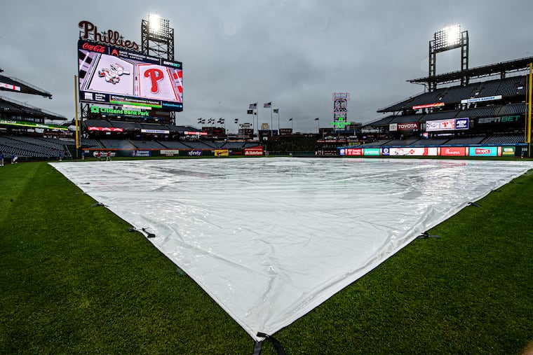 A tarp covers the field during a rain delay at Citizens Bank Park in 2024.