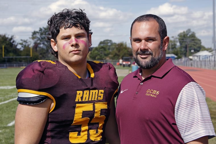 Gloucester Catholic football coach Casey Murphy with his younger brother Kyle, a two-way senior lineman for the Rams.