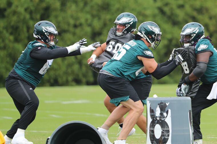 Eagles offensive guard Nate Herbig (left) blocks during Eagles practice on Thursday.