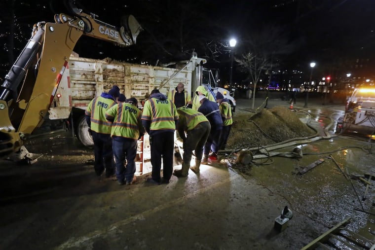 Philadelphia Water Department crews are seen here examining the section of a water main that broke on Wednesday, Dec. 20, 2017, on 18th Street near Locust on the east side of Rittenhouse Square.